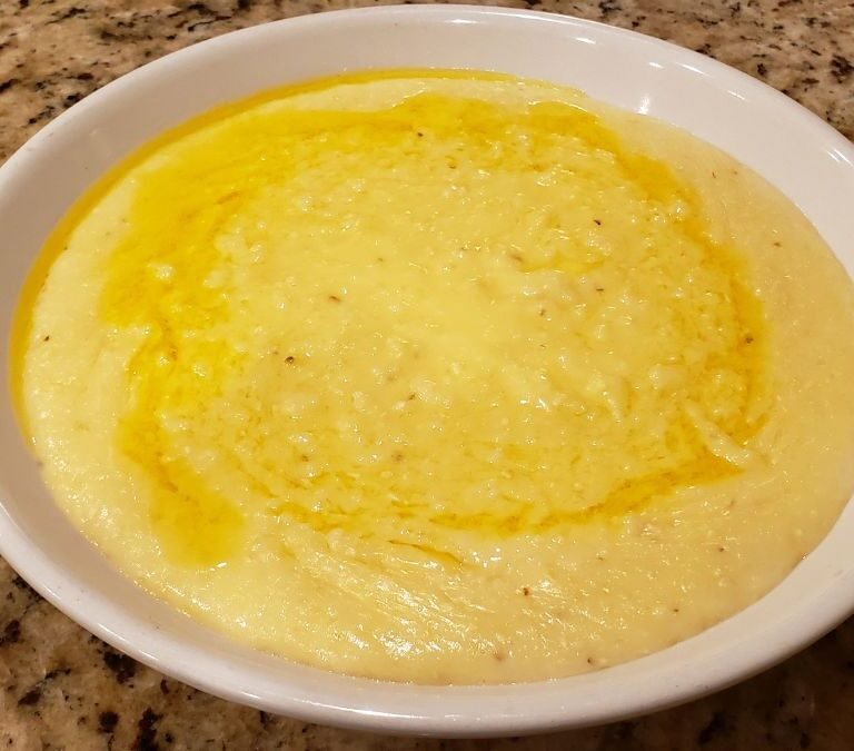 cheese grits in a bowl with butter melted on top