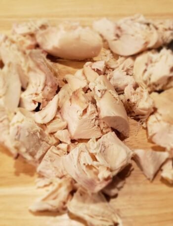 rotisserie chicken breast cut on a cutting board